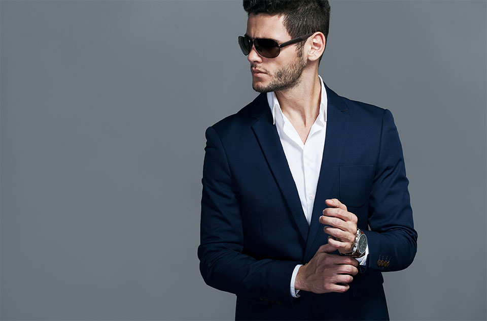 Elegant young handsome man wearing glasses and wathers. Studio fashion portrait.